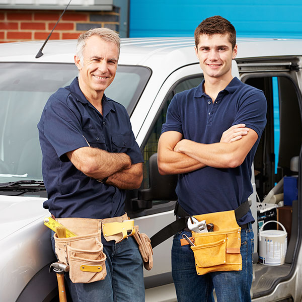 Contractors with heavy-duty work trucks loaded for plumbing, HVAC, or electrical contracting services.