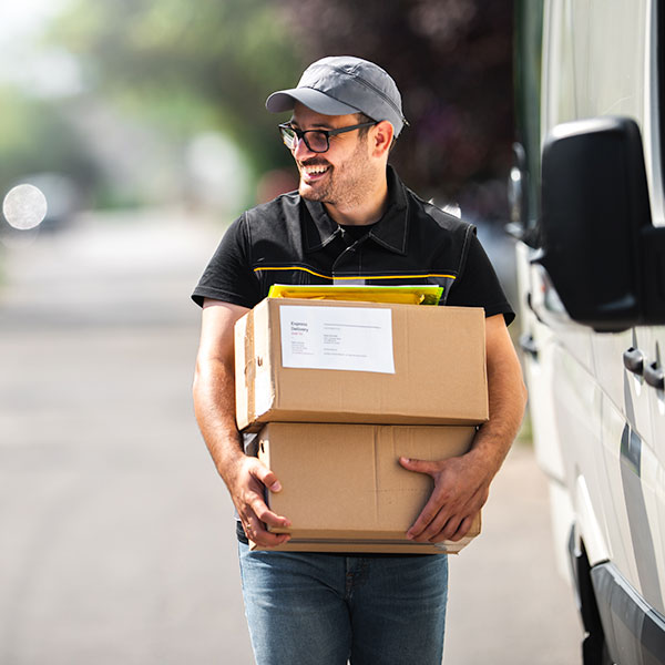 Courier van being loaded with industrial parts and retail products for B2B distribution.